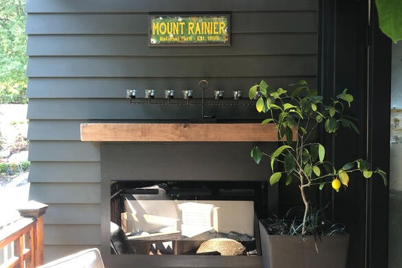 Covered outdoor living area with cedar mantel built by Luna Park Construction