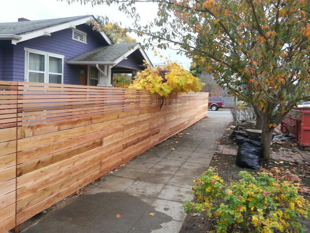 Horizontal cedar fence built alongside a craftsman home