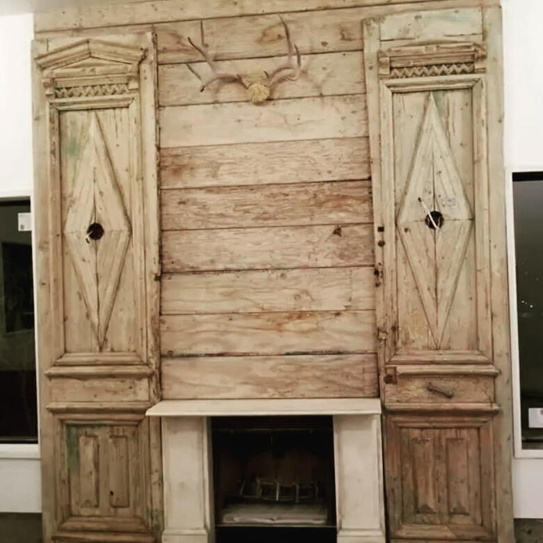 Fireplace surround built from reclaimed wood panels