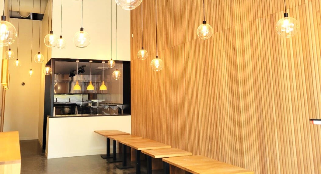 Kitchen and bar remodel with cedar slat wall and pendant lighting by Luna Park Construction
